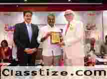 Cdr. K. L. Ganju Presented with Festival Memento by Dr. L. Murugan at 19th Global Film Festival Noida